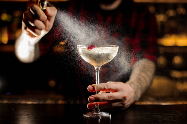 istock Bartender sprinkling bitter on the elegant cocktail glass 1089829600