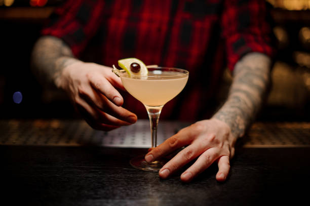 istock Bartender holding fresh juicy cocktail with orange and cherry 1089829936