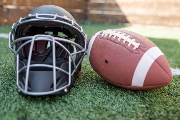 istock Rugby helmet with ball on green grass 1089836474