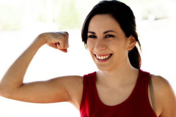 istock Smiling Young Hispanic Woman Outdoors Showing Biceps 1089838654