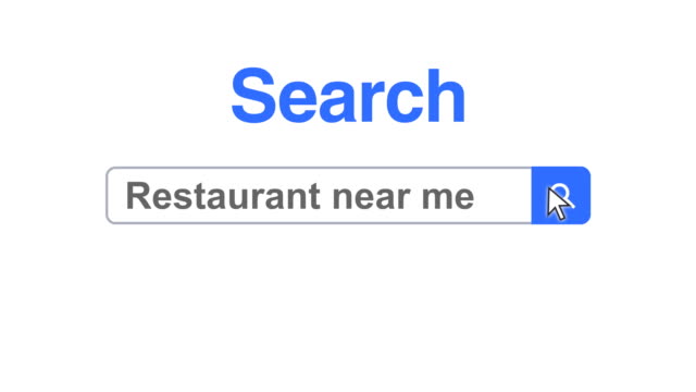 Web browser or web page with a search box typing restaurant near me for internet searching