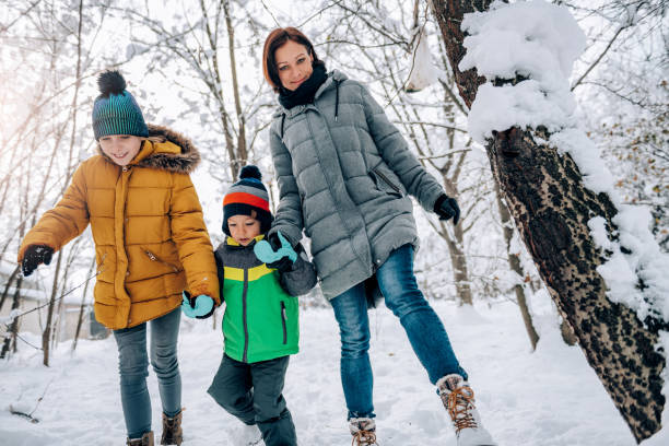 istock Family walking on a fresh snow 1089846702
