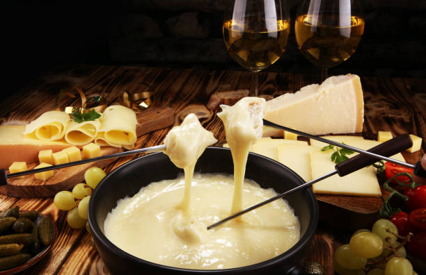istock Gourmet Swiss fondue dinner on a winter evening with assorted cheese 1089848648