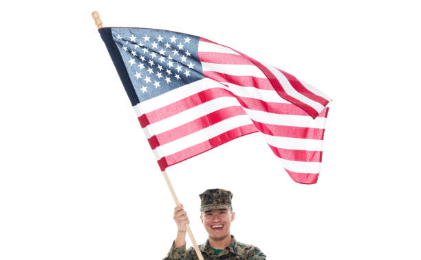 istock US Marine in uniform holding the US flag 1089852074