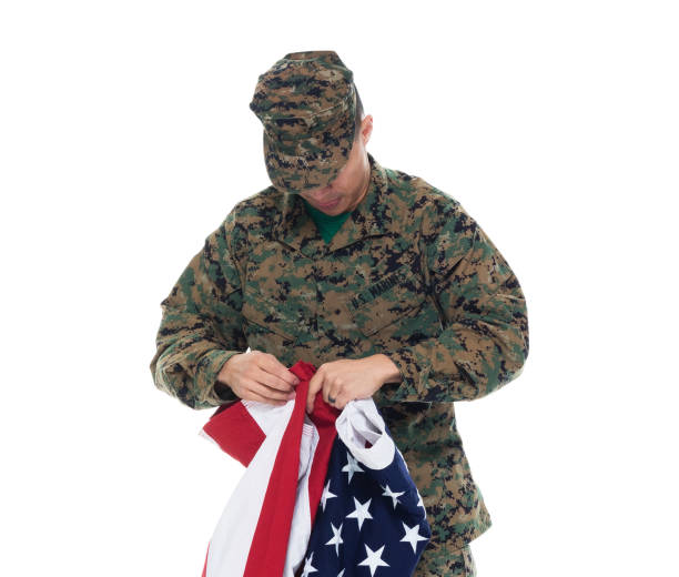 istock US Marine in uniform holding the US flag 1089852098