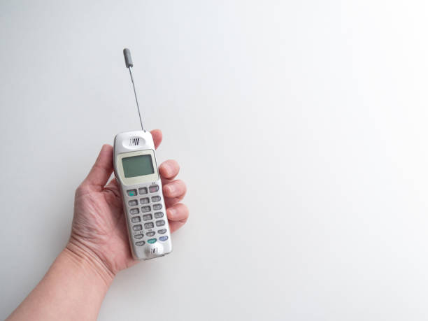 Obsolete cell phones on old weathered wooden table