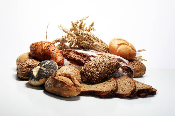 istock Different kinds of bread and bread rolls on board from above. 1089853336