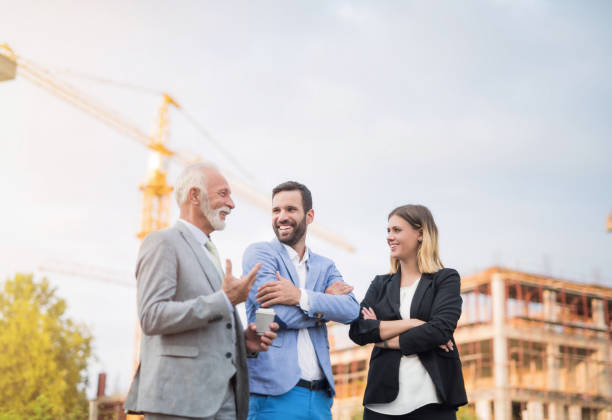 Happy business people on a construction site. Happy business people on a construction site. financial occupation stock pictures, royalty-free photos & images