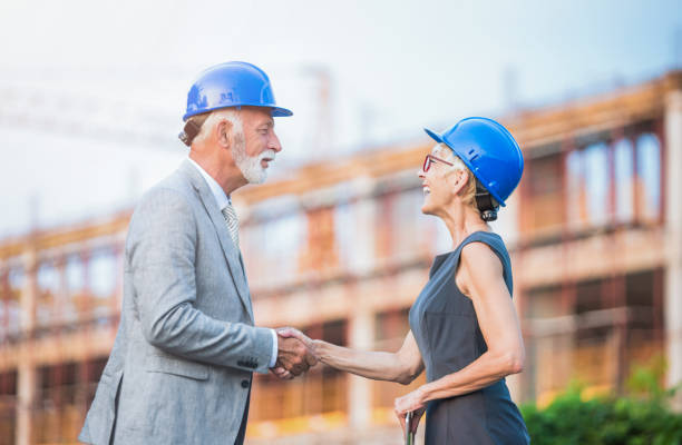 istock Senior investors shaking hands on a construction site. 1089866416