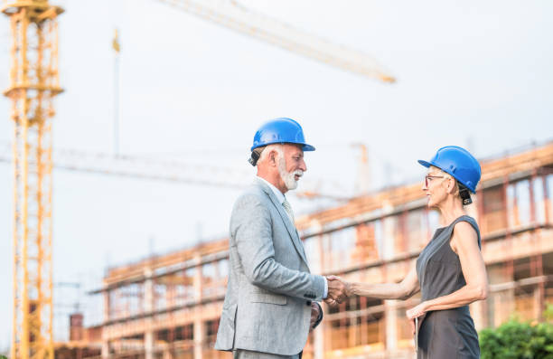 istock Senior investors shaking hands on a construction site. 1089867946
