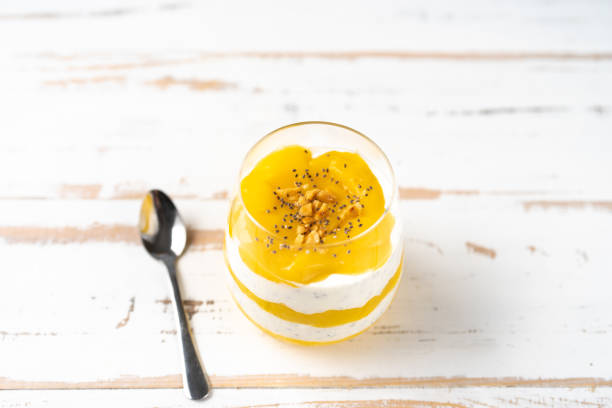 istock Close up of mango smoothie with yogurt on white table 1089870216