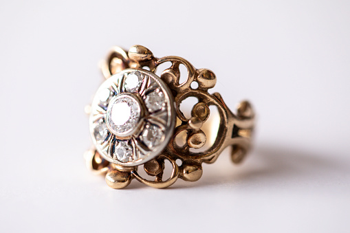 Vintage gold ring with an intricate design and multiple diamonds