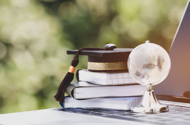 istock Education in crystal global, Graduation cap on top textbook with keyboard computer. Concept of online abroad international Educational, Back to School and Studies lead to success in world wide. 1089897898