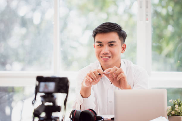 istock Happy Asian businessman videoblog / blogger vlogger recording online course or tutorial strategy presentation pass video for teaching live marketing sharing social media channel by mirrorless camera 1089897932