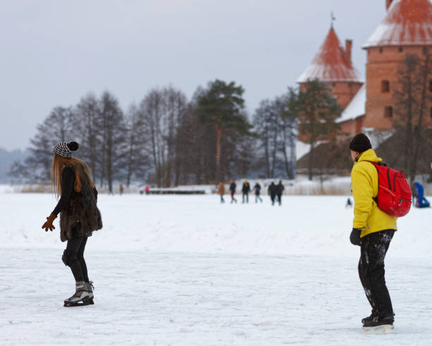 istock Young couple Ice skating on ice covered lake in Trakai 1089897950