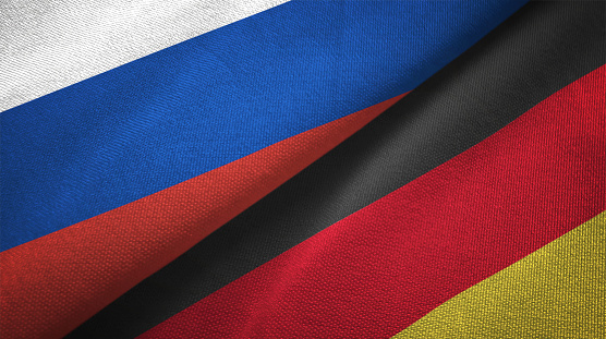 Polish and Ukrainian flags flying in the wind. Poland stand with Ukraine. 3D rendered image.