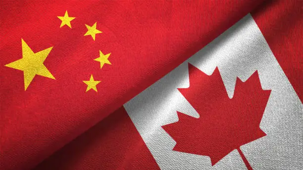 Photo of Canada and China two flags together realations textile cloth fabric texture