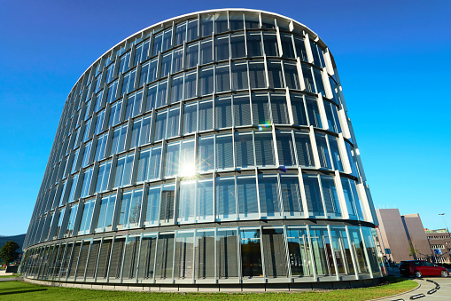 Vilnius, Lithuania - August 8, 2017: Commercial architecture of modern glass and steel forum skyscraper reflecting the blue sky