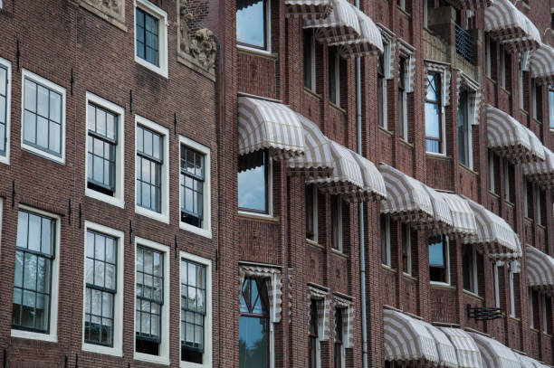 brick house in amsterdam with white window shutters