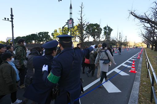 Tokyo,Japan-January 2, 2019: Metropolitan Police Officers control the flow of the people to visit the Palace for the New Year Greeting