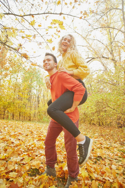 istock Young couple in love in autumn forest 1089938344