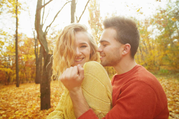 istock Young couple in love in autumn forest 1089938442