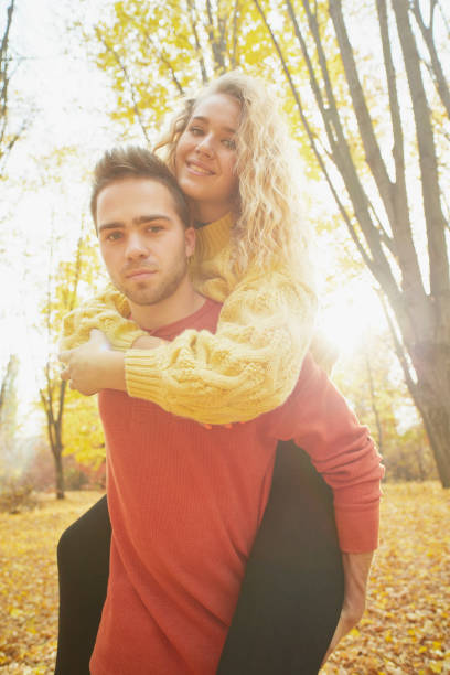 istock Young couple in love in autumn forest 1089940004