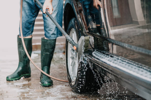 istock man washes modern car in  yard 1089955648