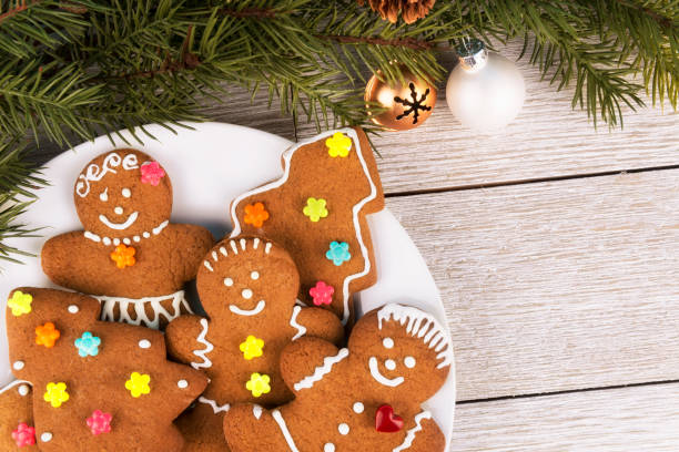 istock Gingerbread cookies and Christmas tree branch on a wooden table. 1089959740