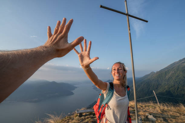 istock Personal perspective of Two hikers celebrating on mountain top with a high five 1089986310