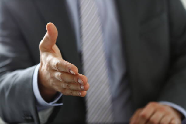 istock Man in suit and tie give hand as hello 1089987106