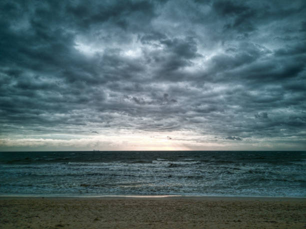 istock Dramatic moody sky and waves as Tropical Storm Pabuk approches 1089991136