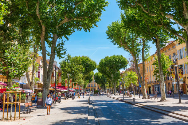 street Cours Mirabeau in Aix-en-Provence, France Aix-en-Provence, France - July 27, 2016: street Cours Mirabeau with unidentified people. 440 meters long and 42 meters wide, the Cours Mirabeau is one of the most popular and lively places in the town cours mirabeau aix en provence stock pictures, royalty-free photos & images