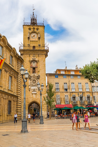 Aix-en-Provence, France - July 27, 2016: historic city hall and clock tower and unidentified people. Aix-en-Provence is University city and the historical capital of the Provence.