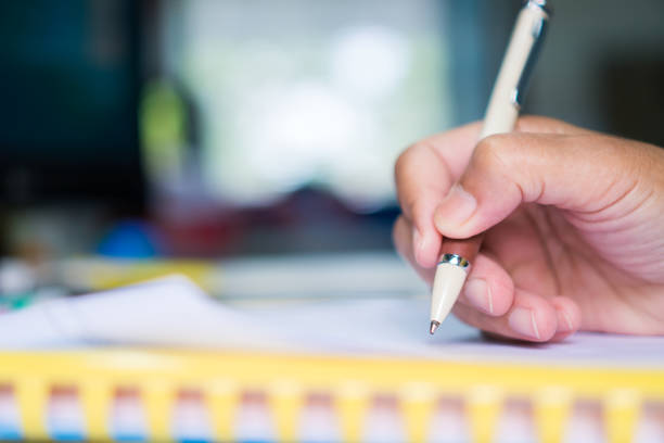 istock Businessman hands working and writing data in computer, Stacks of paper files for searching information on work office, business report papers,piles of unfinished documents achieves 1089995338