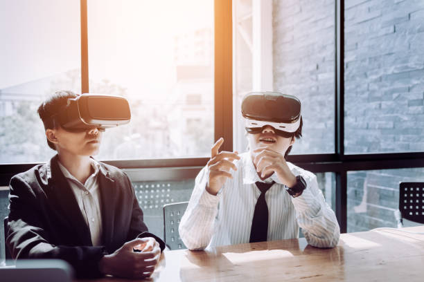 istock Two business persons with virtual reality headsets in the office. 1090000674