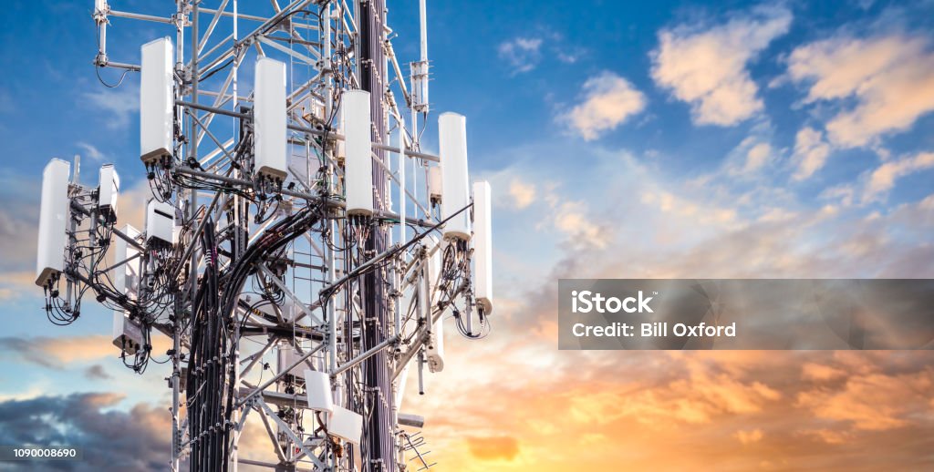 5G Sunset Cell Tower: Cellular communications tower for mobile phone and video data transmission 5G Stock Photo