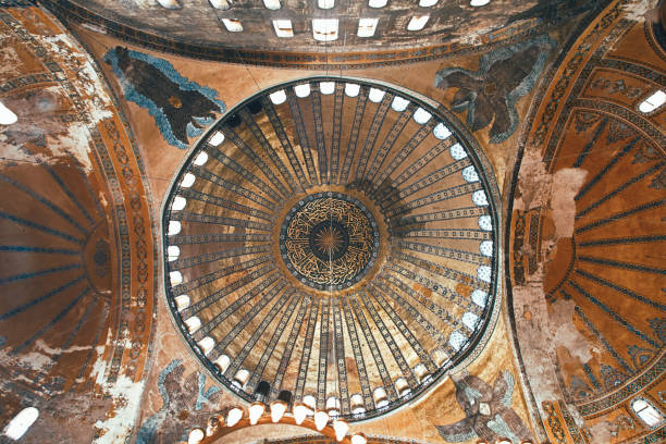 Istanbul, Turkey - April 25, 2013: Turkish and foreign tourists in the south aisle of the famous former basilica and mosque, Hagia Sofia, in the Sultanahmet district of Istanbul.