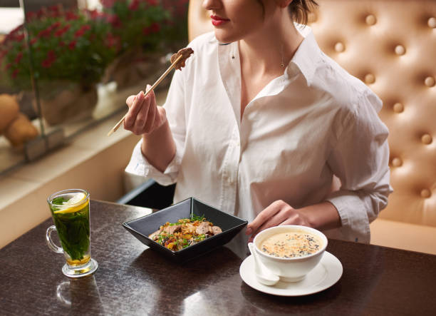 istock Woman ordering oriental style meal in restaurant. 1090011078