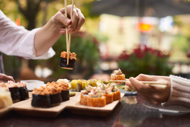 Sisters enjoying oriental meal from rice and seafood. stock photo
