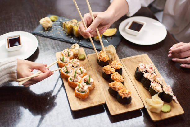 istock Colleagues ordering sushi on lunch in oriental restaurant. 1090011156