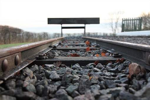 Close up of railway track with track ballast stones.
