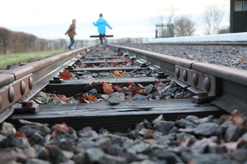 Young boys playing on miniature railway tracks
