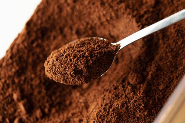 Ground coffee in spoon Ground coffee in spoon, natural coffee background, macro caffeine stock pictures, royalty-free photos & images