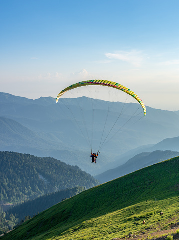 Paraglider in blue clear sky over the Green Mountain