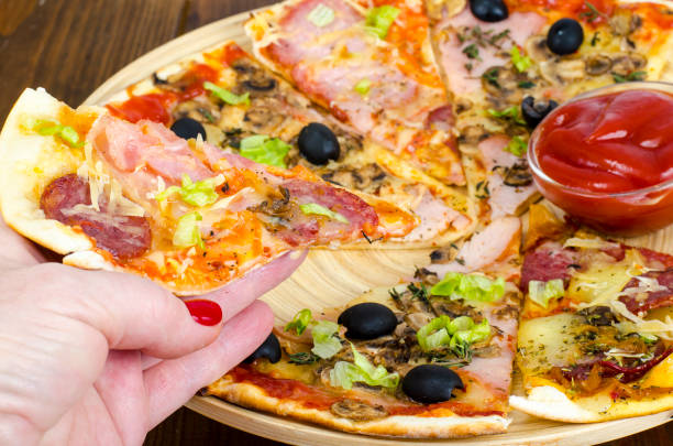 istock Female hand with slice of pizza 1090016372