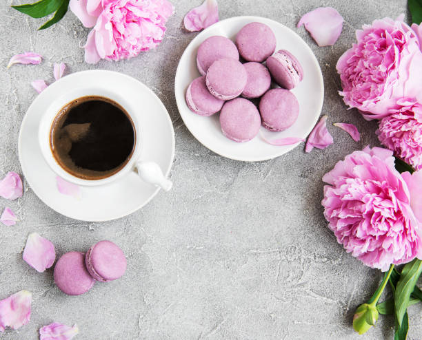 istock Pink peony with coffee and macarons 1090024158
