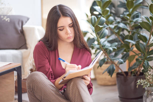 istock girl writes in her diary at the home 1090024966
