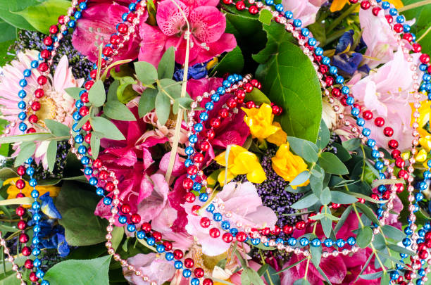 Bouquet of flowers and colored beads for Mardi gras
