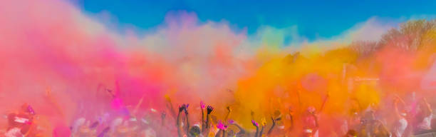 Holi Festival Dahan Crowd throwing bright coloured powder paint in the air, Holi Festival Dahan india crowd stock pictures, royalty-free photos & images